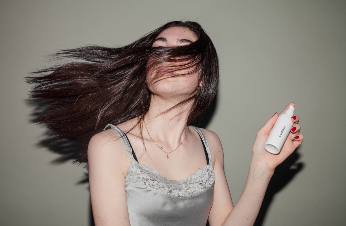 Photo by Curology woman holding spray bottle